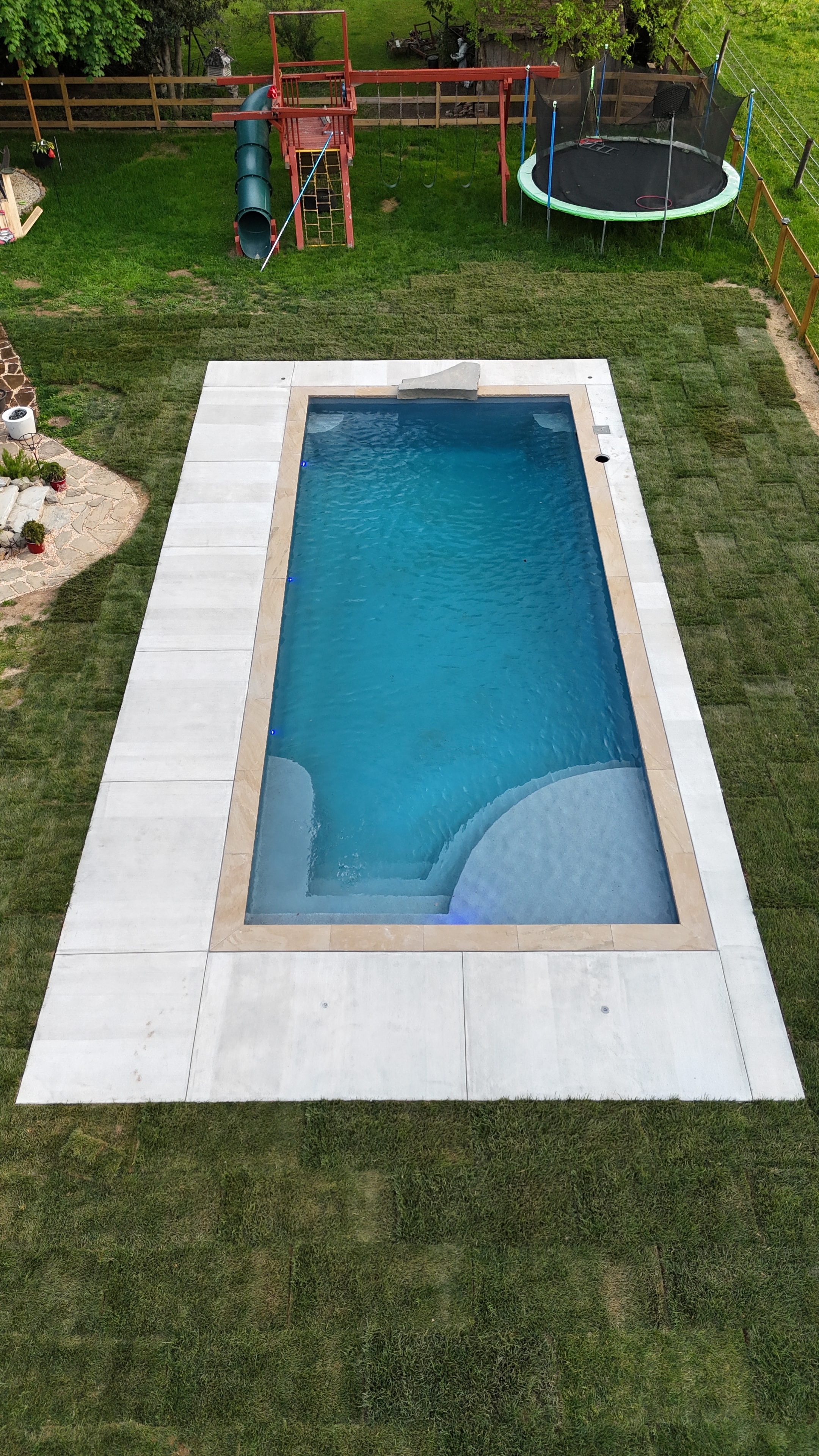 LandPro aerial daytime shot of pool with concrete and travertine coping