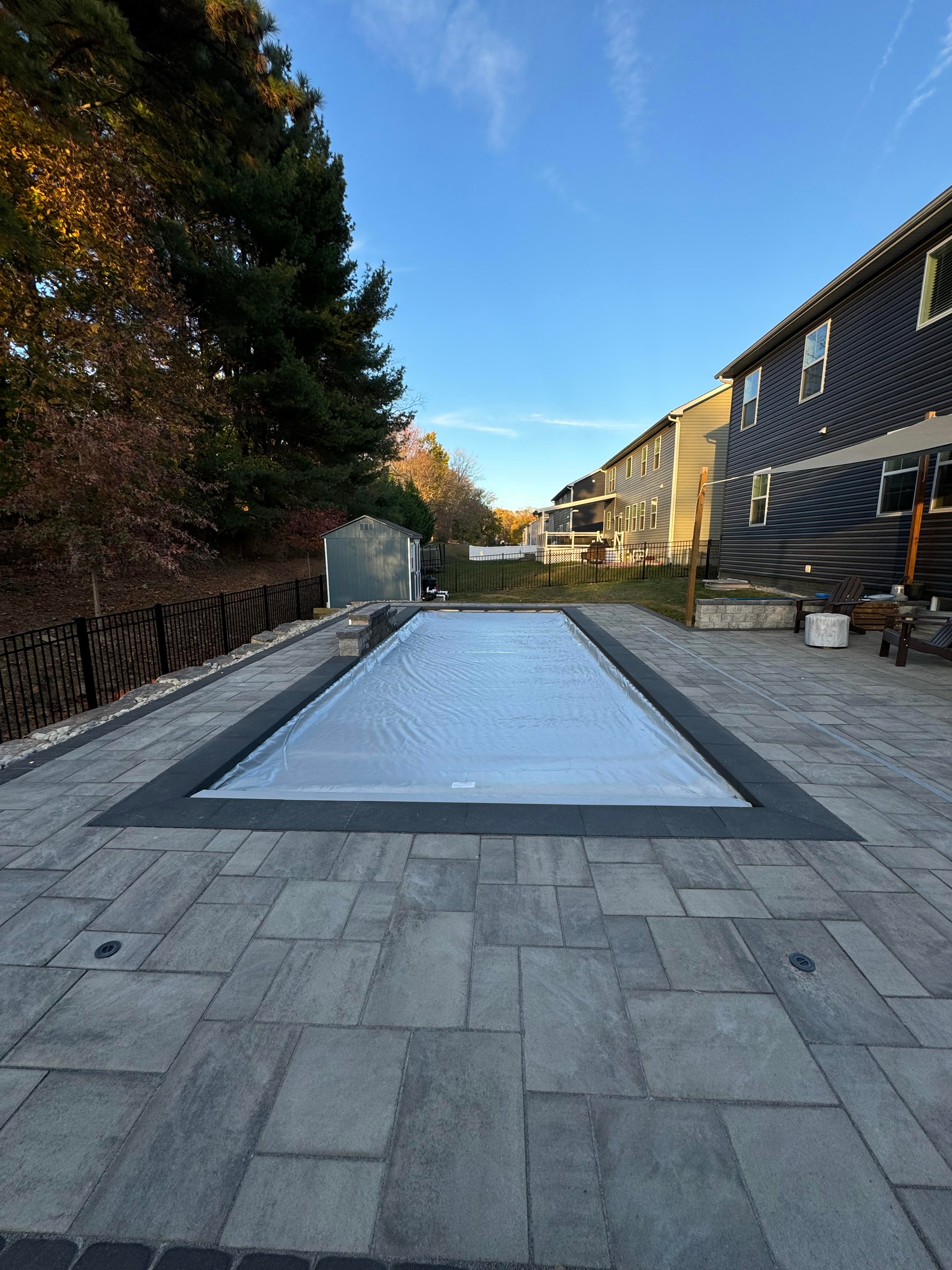 LandPro pool installation with paver patio and sitting wall