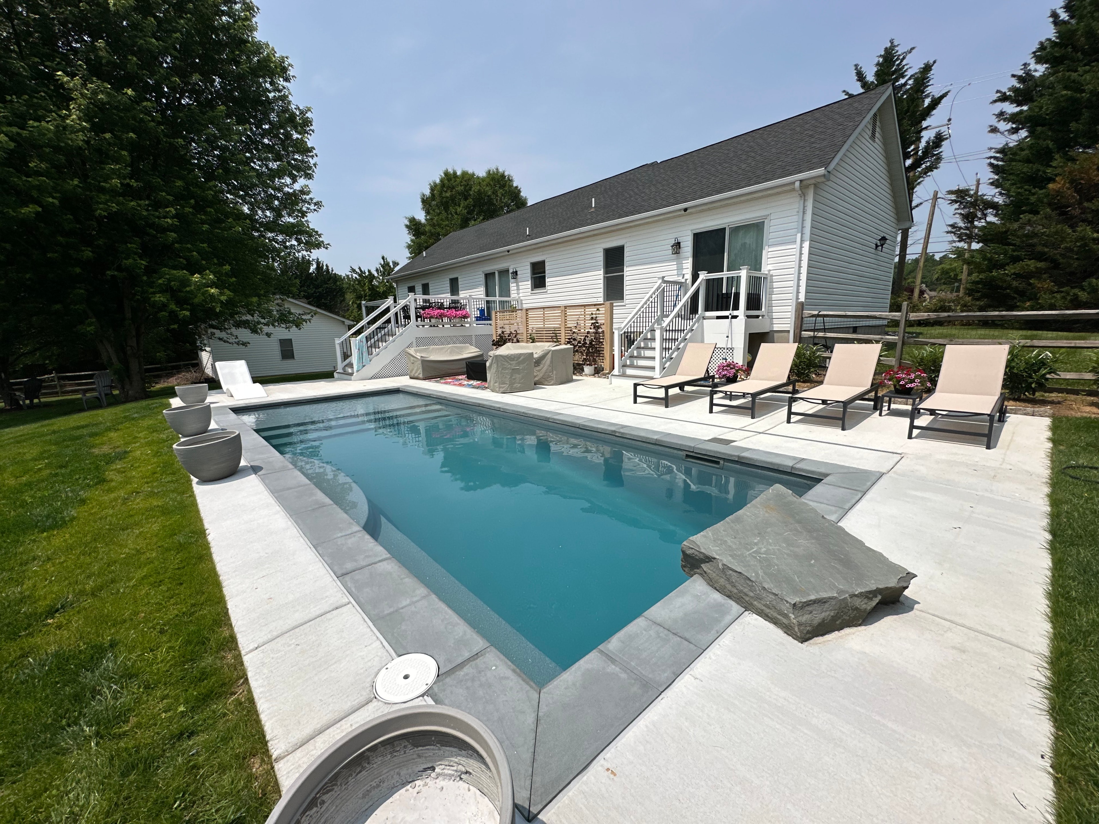 Backyard for the Kids — wide view of pool, patio, and house with lounge chairs