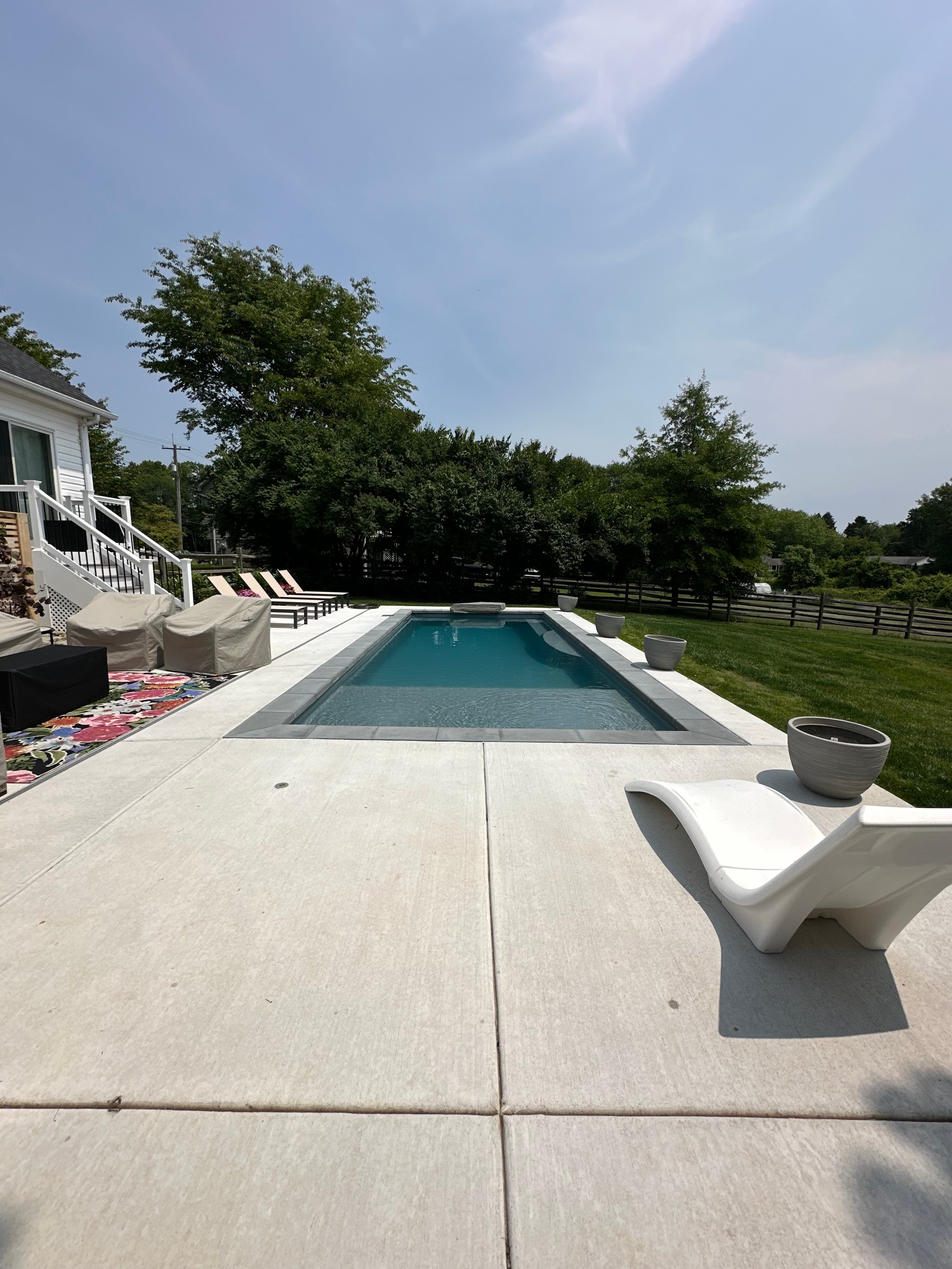 Backyard for the Kids — wide angle of pool with slide and patio surround