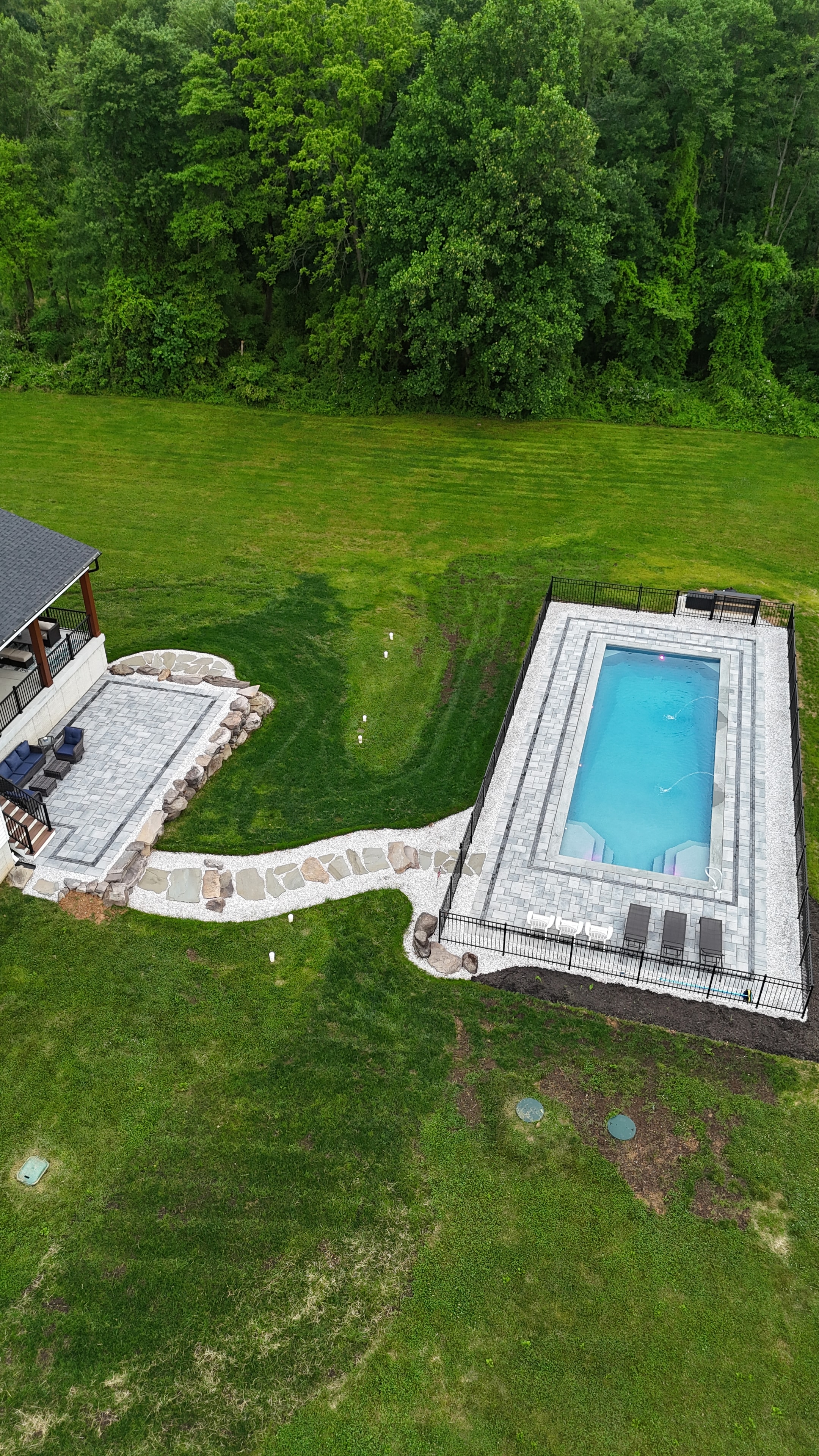 Country Oasis — wide aerial showing full property with pool and patio connected by stone path