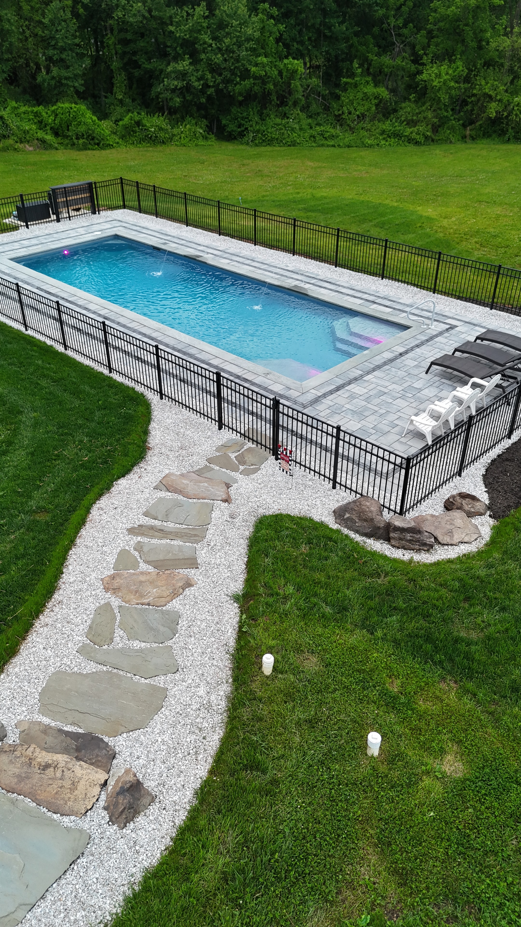 Country Oasis — aerial daytime view of pool with stone pathway and patio