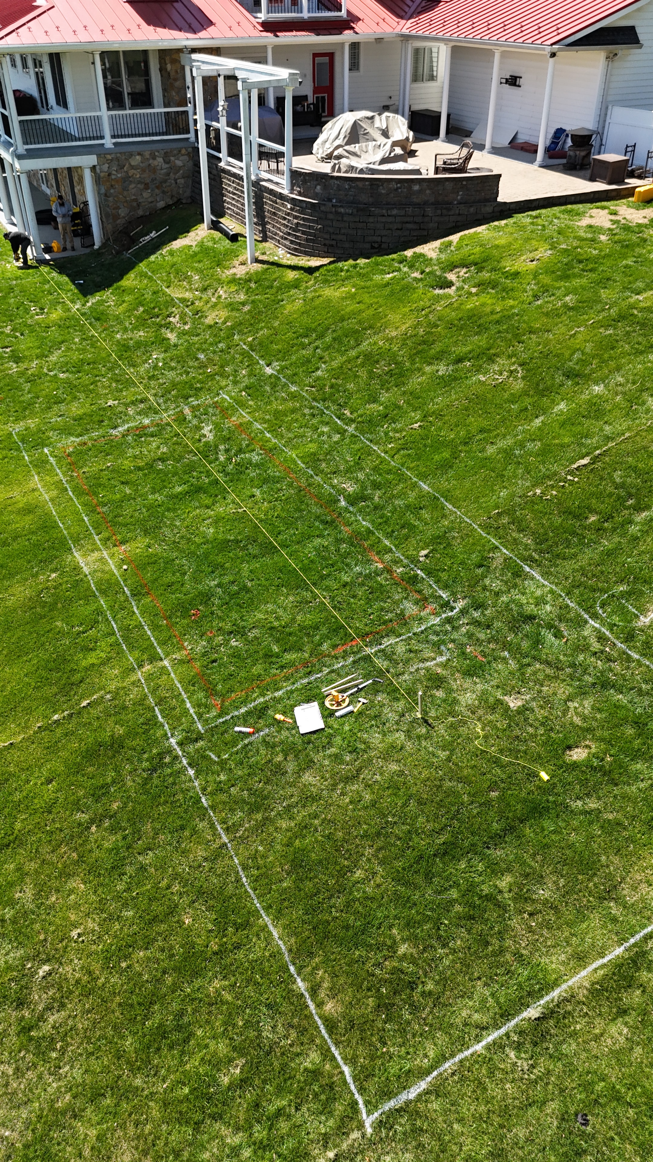 Under construction — aerial layout markings on hillside before excavation