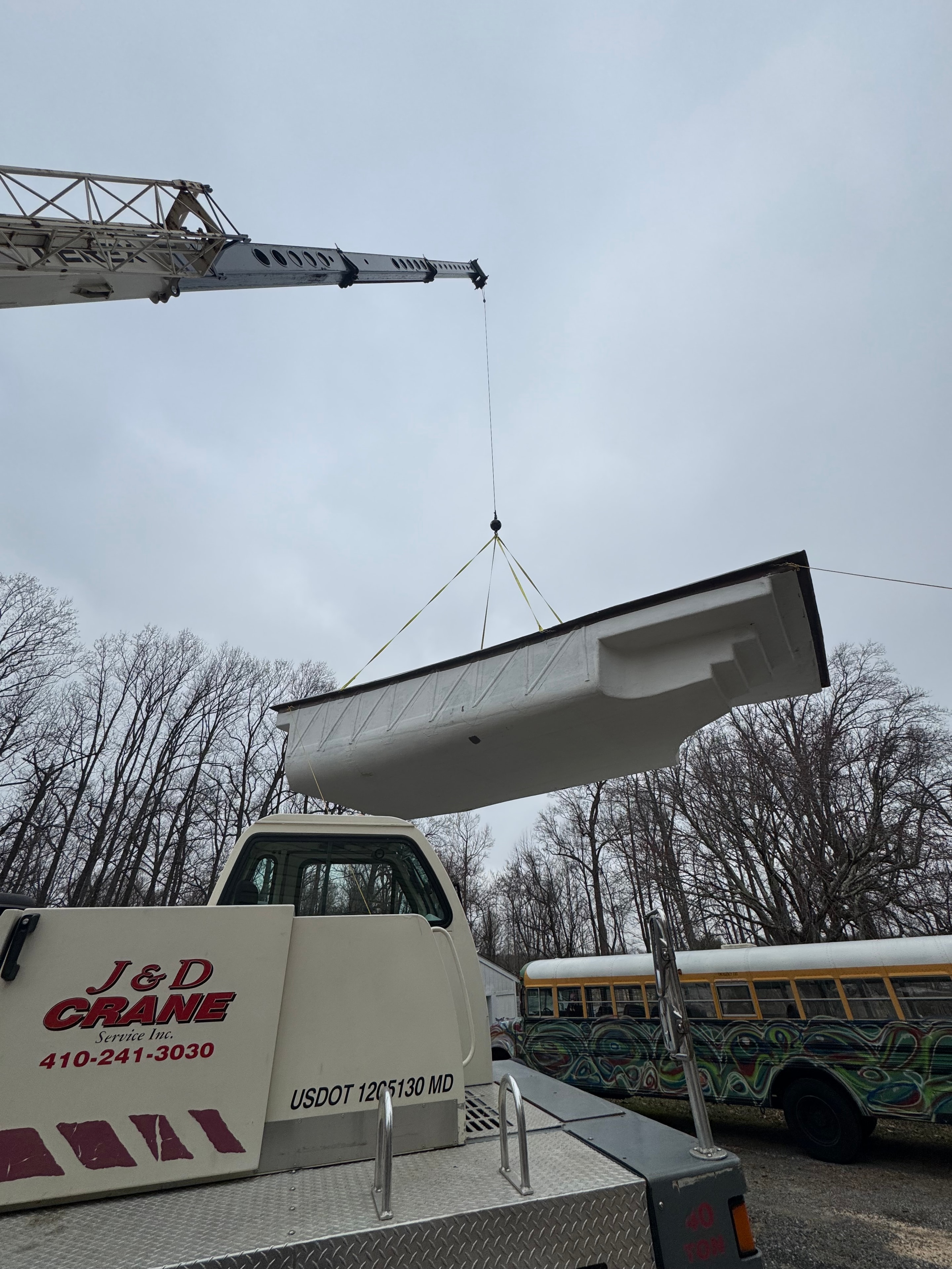 Under construction — J&D Crane lifting fiberglass pool shell for installation